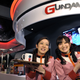 Staff at the Gundam Cafe in Akihabara wear Gundam themed outfits and hold trays with drinks.